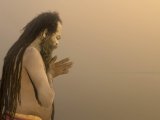 Varanasi, Sadhu prays to the rising sun at dawn